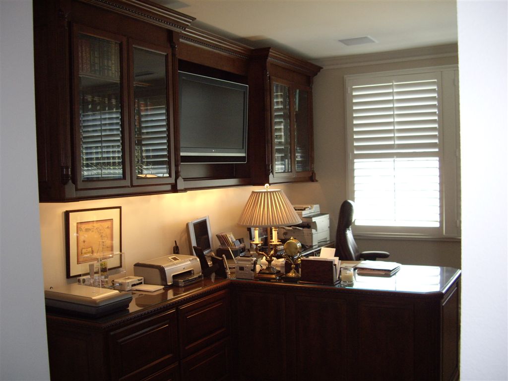 Custom home office design for a stock broker with a built in tv. | C