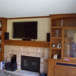Custom built in shelves with mantel and tv over fireplace