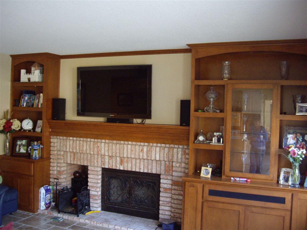 Custom built in shelves with mantel and tv over fireplace C & L