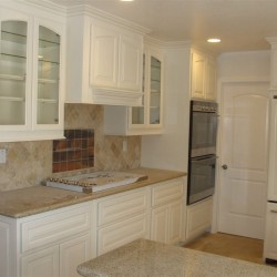 White lacquer kitchen cabinetry with glass doors