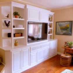 Entertainment center with angled corners and see through shelving in Carlsbad, CA.