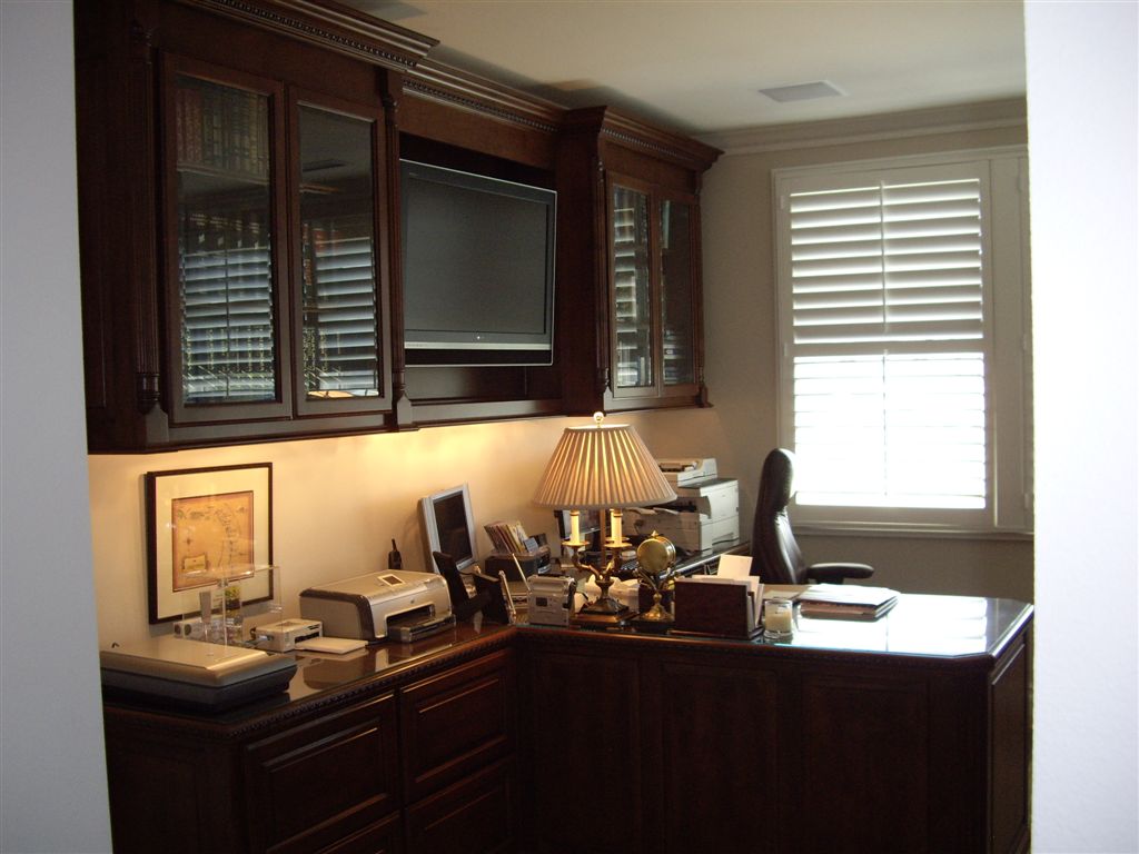 Custom home office design for a stock broker with a built in tv.