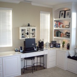 Custom, home office desk finished in white lacquer with bookshelves and window seat