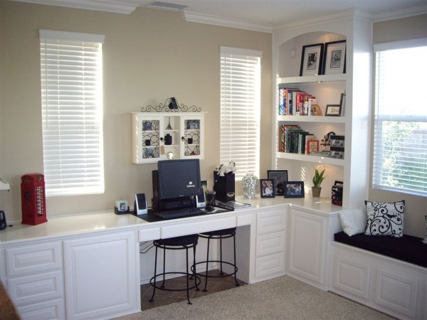 Custom, home office desk finished in white lacquer with bookshelves and window seat