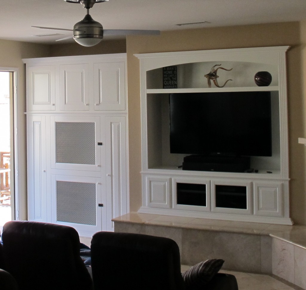 Dog kennel built into white wall wall unit